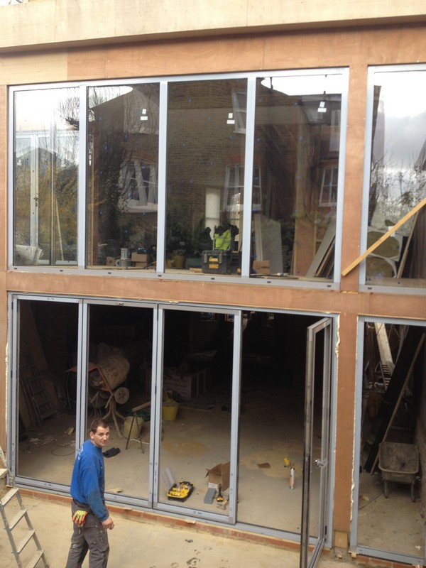 Aluminium bi-fold doors with two-storey glazing in  Bromley by Bow