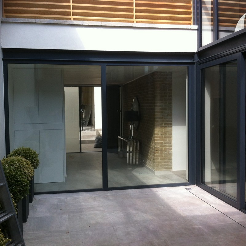 Floor-to-ceiling sliding doors opening to courtyard in  Bromley by Bow