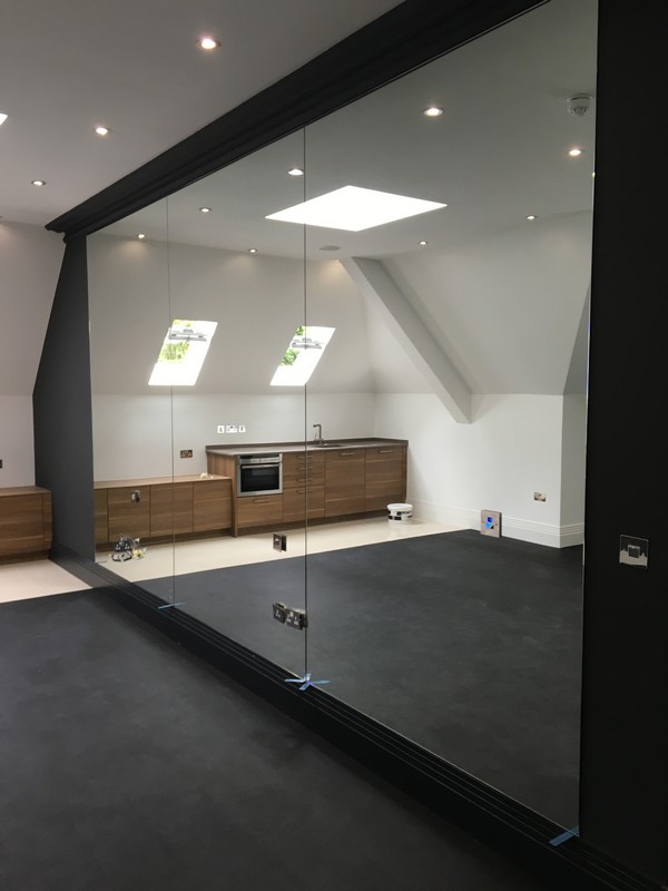 Frameless glass partition in loft conversion by  Bromley by Bow glaziers