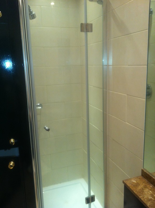 Frameless glass shower enclosure with chrome fittings in  Bromley by Bow