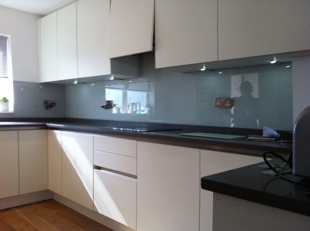 Grey glass kitchen splashback with LED lighting in  Bromley by Bow