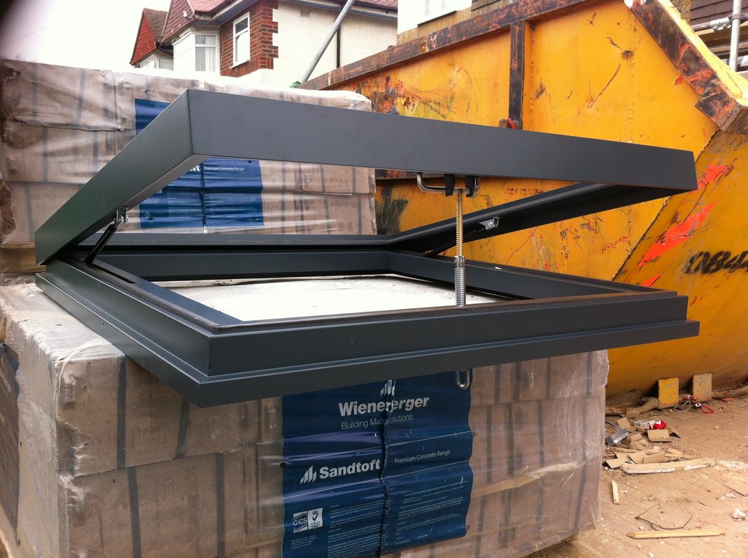 Opening flat roof skylight in anthracite grey installed in  Bromley by Bow